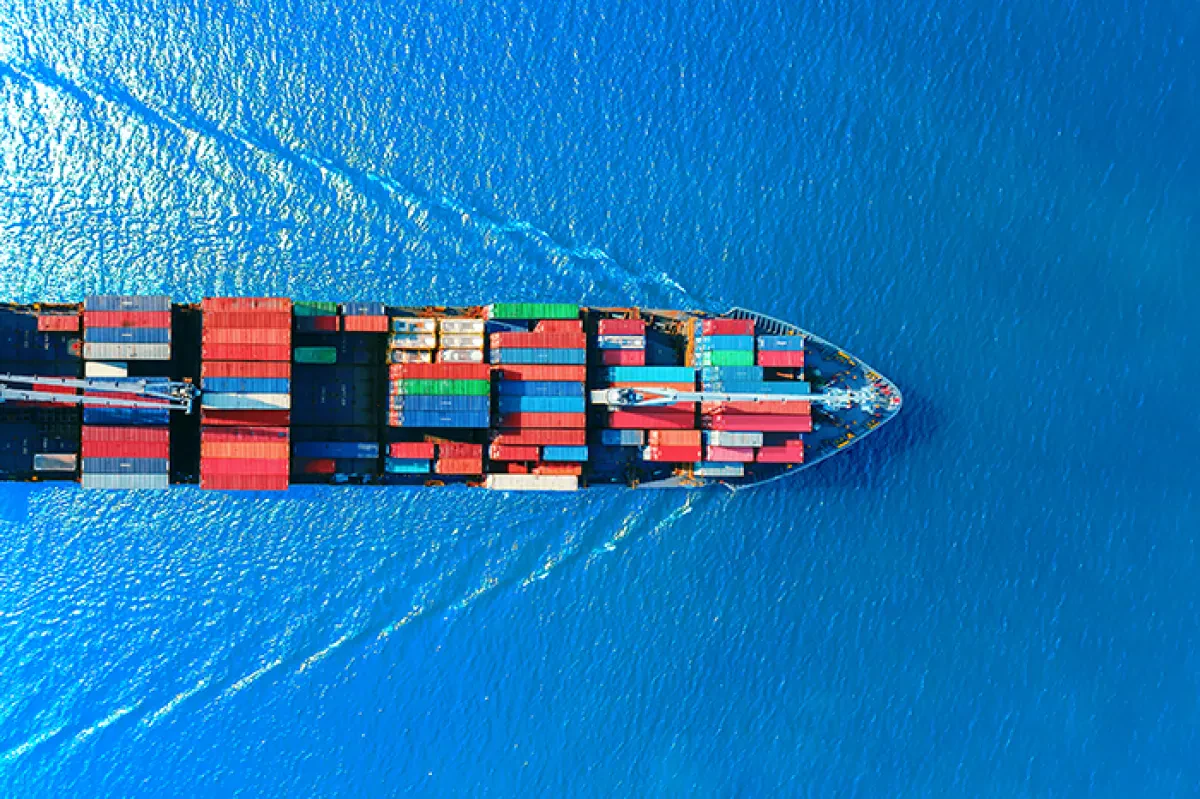 Container-ship-horizontal-overhead-bright-blue-water